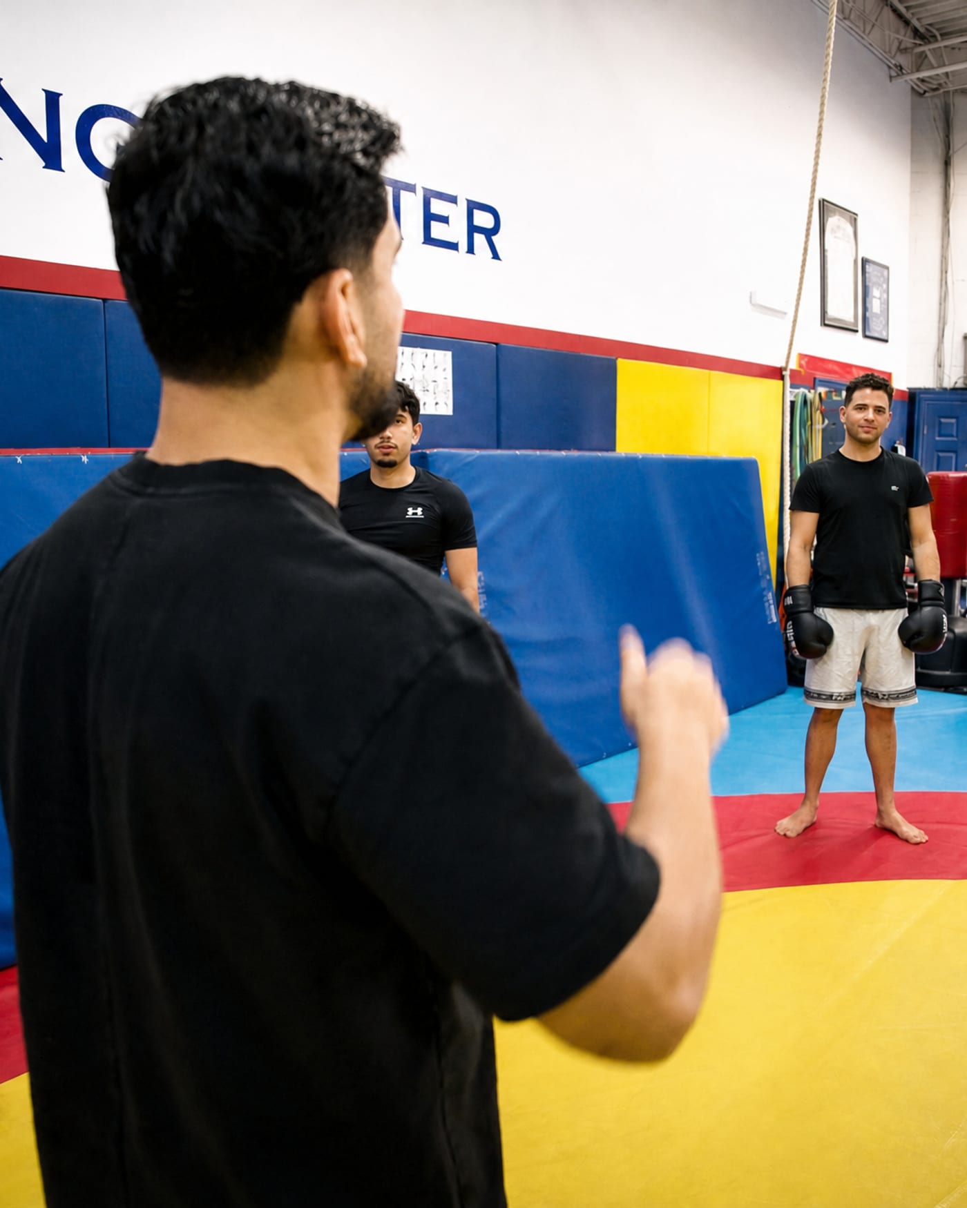 Coach directing a kickboxing class on the mat at Private Kombat